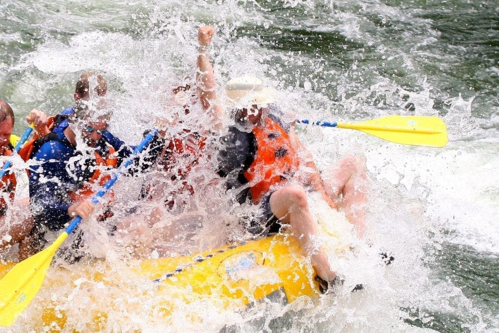 Bull riding on the Blackfoot River whitewater trip.