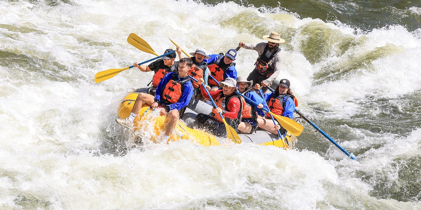 guide and participants on clark fork whitewater rafting trip