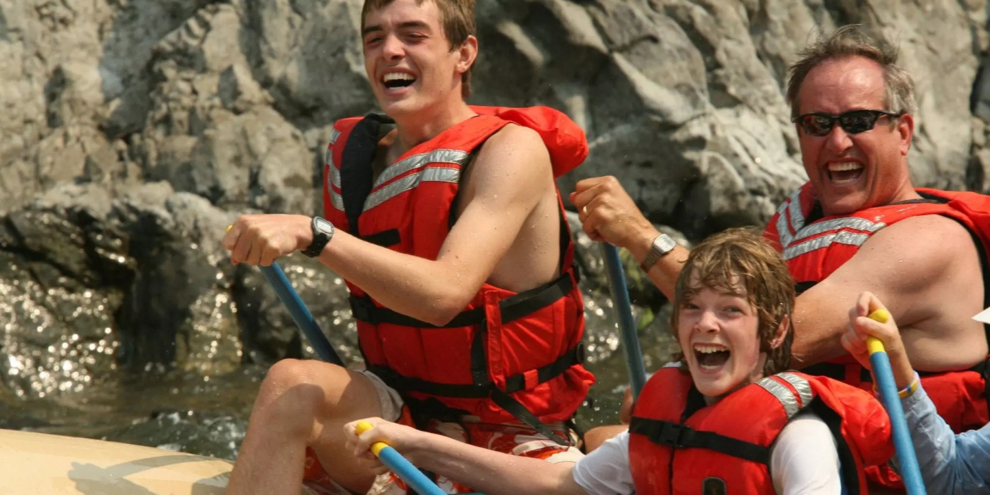 smiling father and sons during blackfoot river float trip