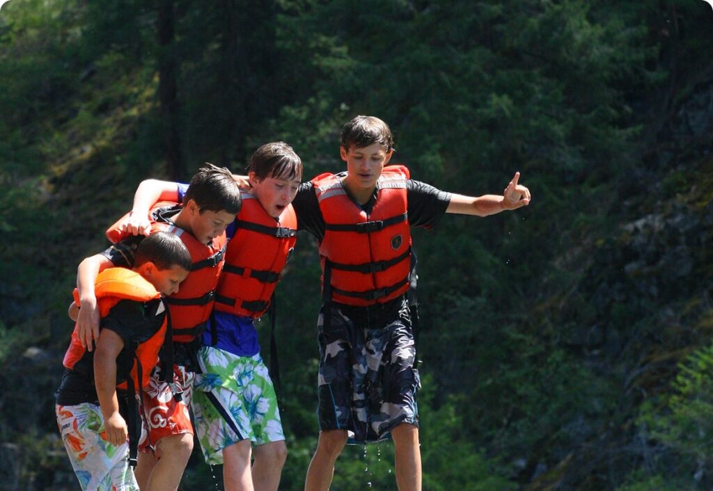 kids jumping on group rafting trip