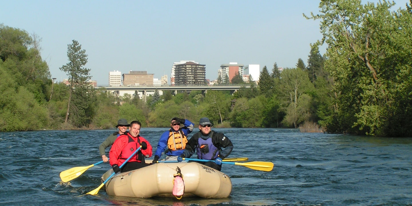 participants on calm stretch of spokane river family rafting