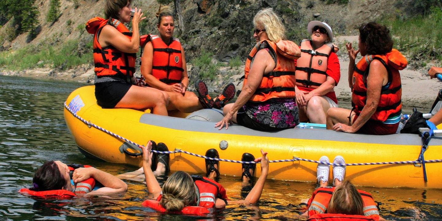 group of women enjoying missoula wine tasting while rafting on clark fork river